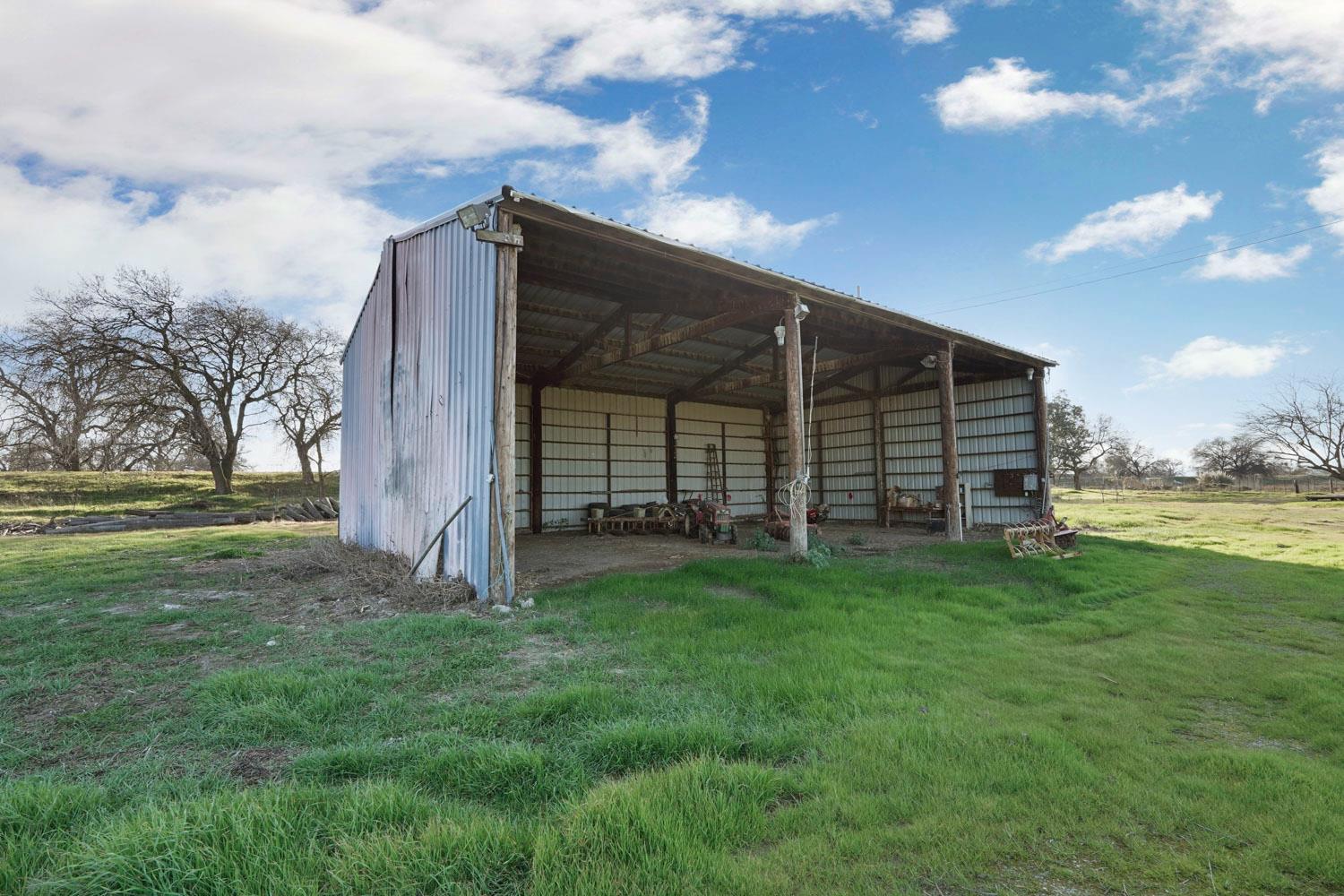 16321 South Wing Levee Road Stockton, CA 95206 - Photo 48 of 71 a view of a backyard with barn and large trees
