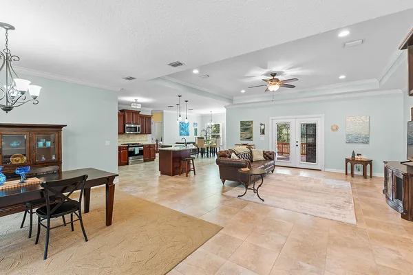 a living room with furniture and a dining table with wooden floor