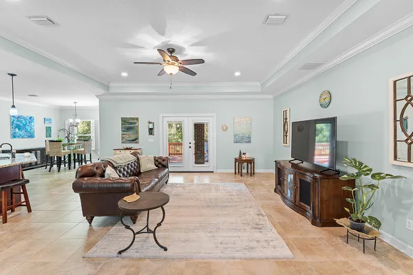 a living room with furniture a rug and a flat screen tv