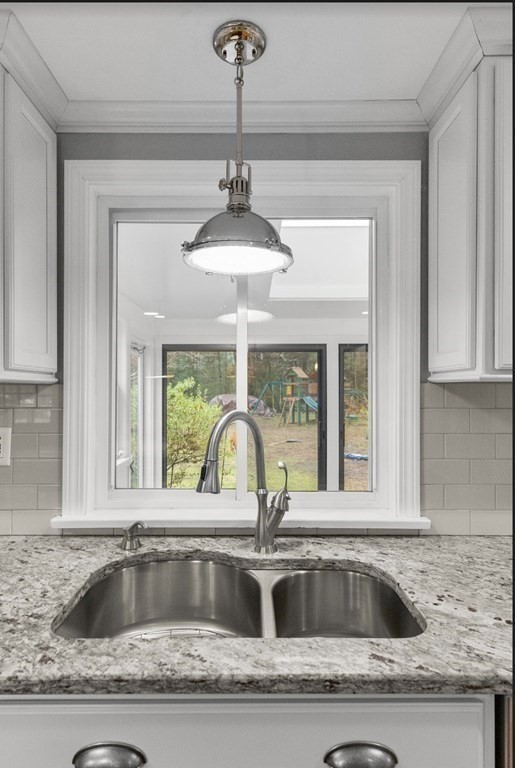 14 Kelsey Road Boxford, MA 01921 - Photo 7 of 39 a view of a kitchen counter top a sink and chandelier