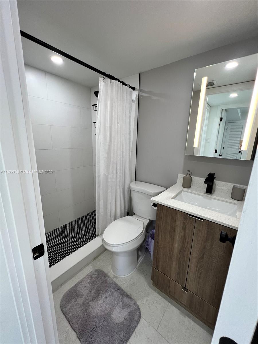 3304 Virginia Street, Unit 6B Miami, FL 33133 - Photo 13 of 15 a bathroom with a sink toilet and shower