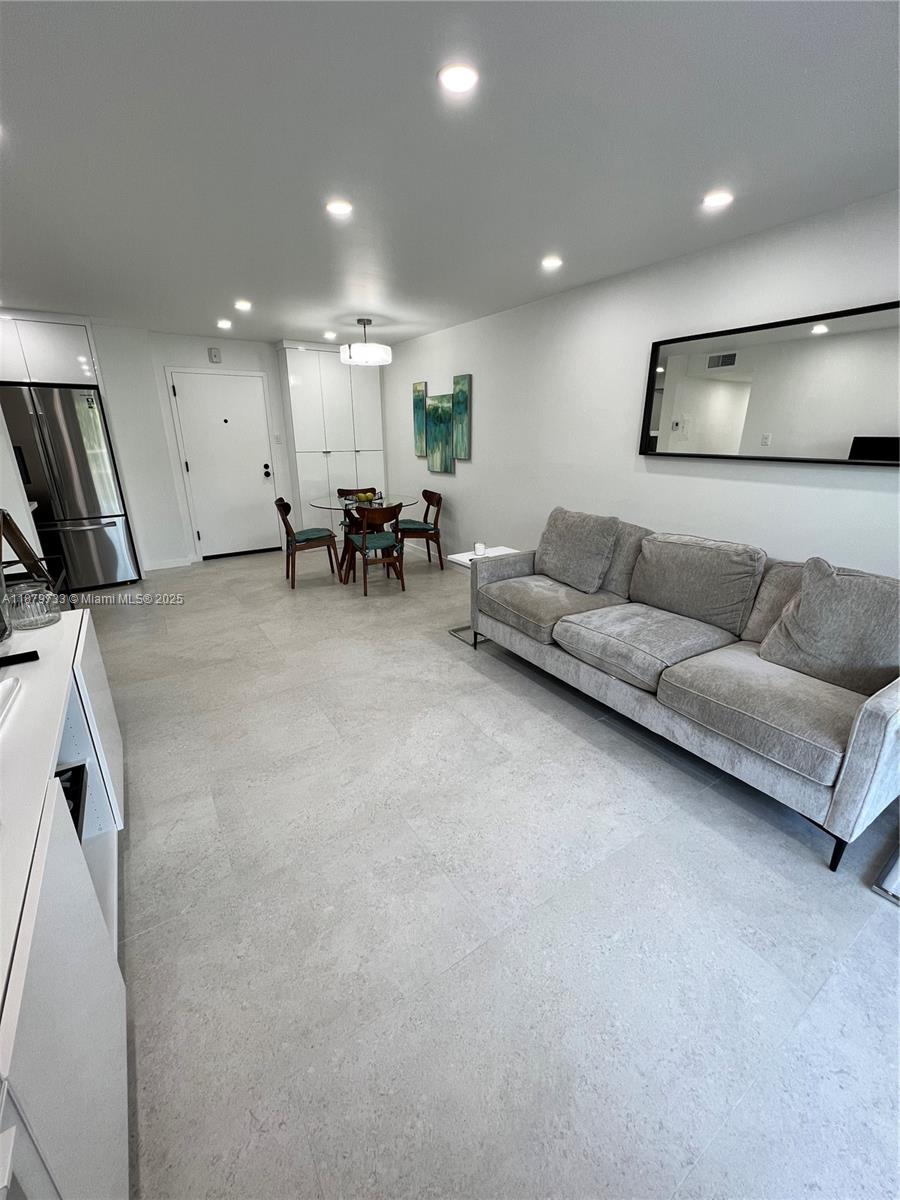 3304 Virginia Street, Unit 6B Miami, FL 33133 - Photo 14 of 15 a living room with furniture and a large mirror