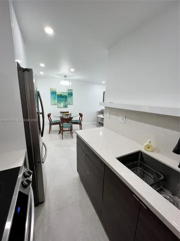 a kitchen with a sink stainless steel appliances and cabinets