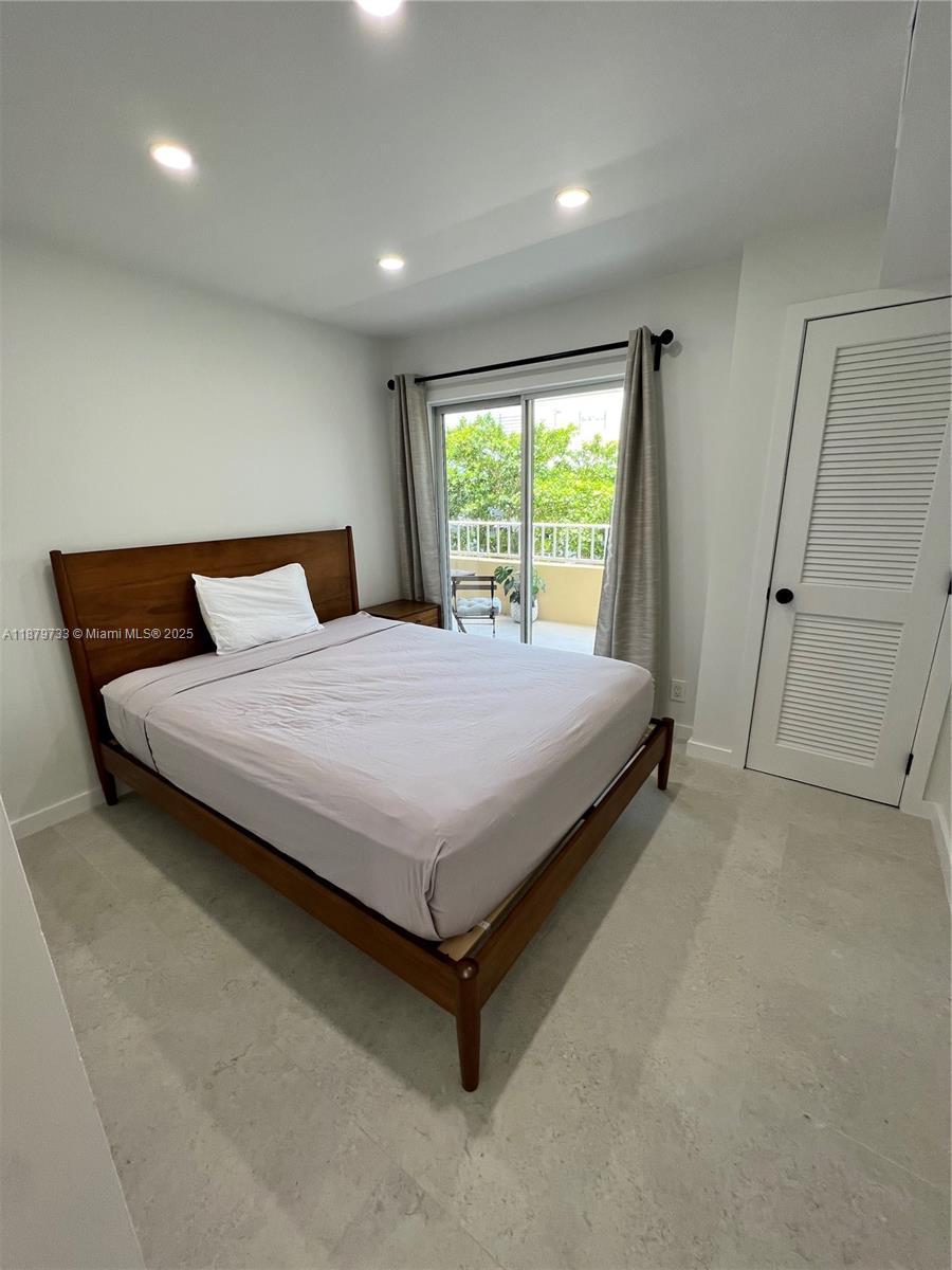 3304 Virginia Street, Unit 6B Miami, FL 33133 - Photo 5 of 15 a bed sitting in a spacious room next to a window