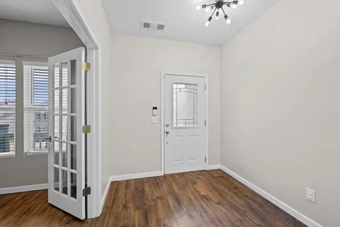 wooden floor in an empty room with a window