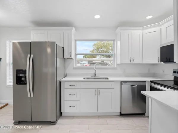 a kitchen with a refrigerator sink and microwave