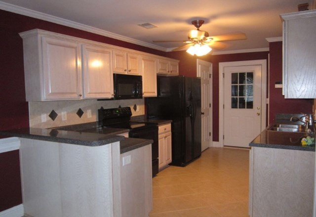 6793 Houston Road Macon, GA 31216 - Photo 2 of 22 a kitchen with a appliances sink cabinets and window