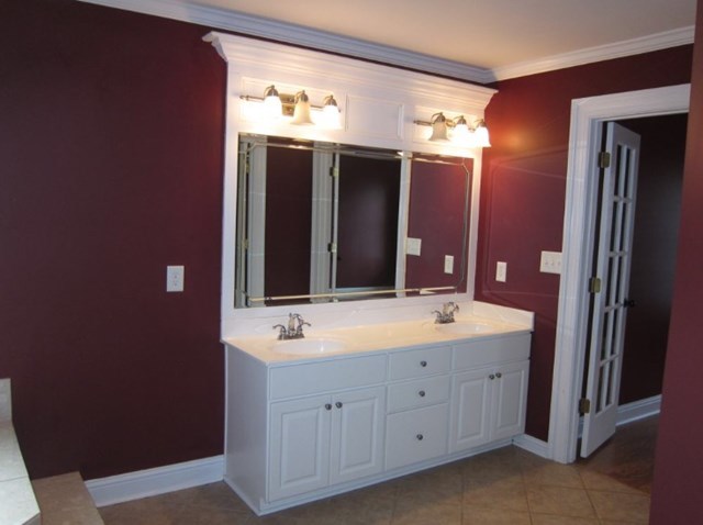 6793 Houston Road Macon, GA 31216 - Photo 12 of 22 a bathroom with a double vanity sink and a mirror