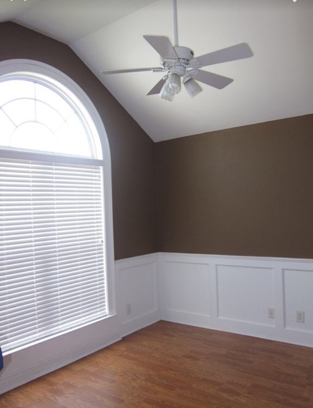 6793 Houston Road Macon, GA 31216 - Photo 14 of 22 an empty room with wooden floor fan and windows