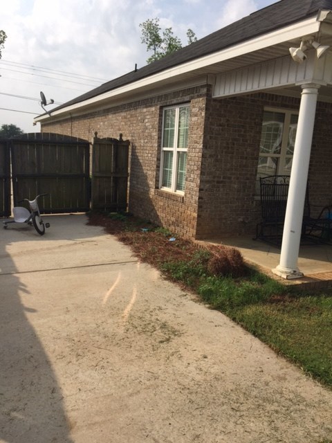 6793 Houston Road Macon, GA 31216 - Photo 18 of 22 a backyard of a house with barbeque oven and wooden fence