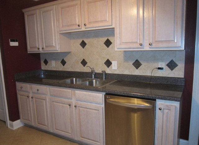 6793 Houston Road Macon, GA 31216 - Photo 3 of 22 a kitchen with granite countertop white cabinets and sink