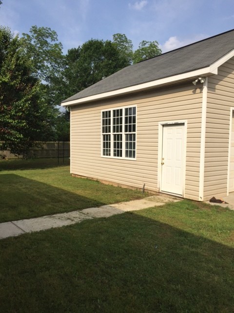 6793 Houston Road Macon, GA 31216 - Photo 21 of 22 a view of a backyard with a garden and plants