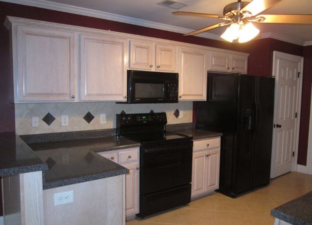 6793 Houston Road Macon, GA 31216 - Photo 4 of 22 a kitchen with stainless steel appliances granite countertop a refrigerator a stove a sink and dishwasher with wooden floor