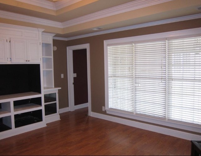 6793 Houston Road Macon, GA 31216 - Photo 8 of 22 a view of an empty room with a window and wooden floor