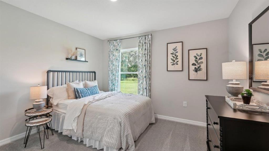 17577 Acorn Drop Road Land O Lakes, FL 34638 - Photo 20 of 23 a bedroom with a bed and a desk