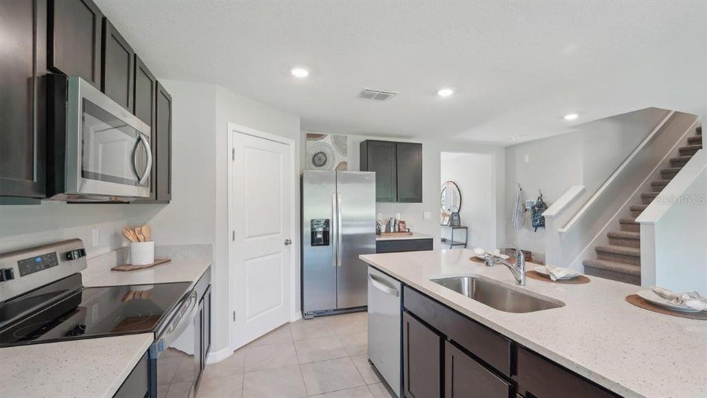 17577 Acorn Drop Road Land O Lakes, FL 34638 - Photo 4 of 23 a kitchen with a sink stove and refrigerator