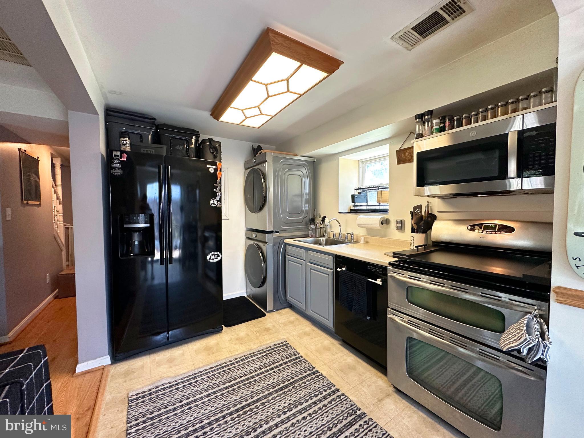 7811 Meath Road Baltimore, MD 21222 - Photo 19 of 52 a kitchen with stainless steel appliances kitchen island granite countertop a refrigerator stove and sink
