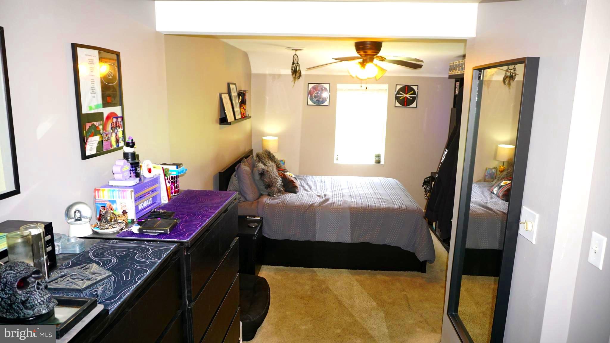 7811 Meath Road Baltimore, MD 21222 - Photo 28 of 52 a bedroom with a bed and wooden floor