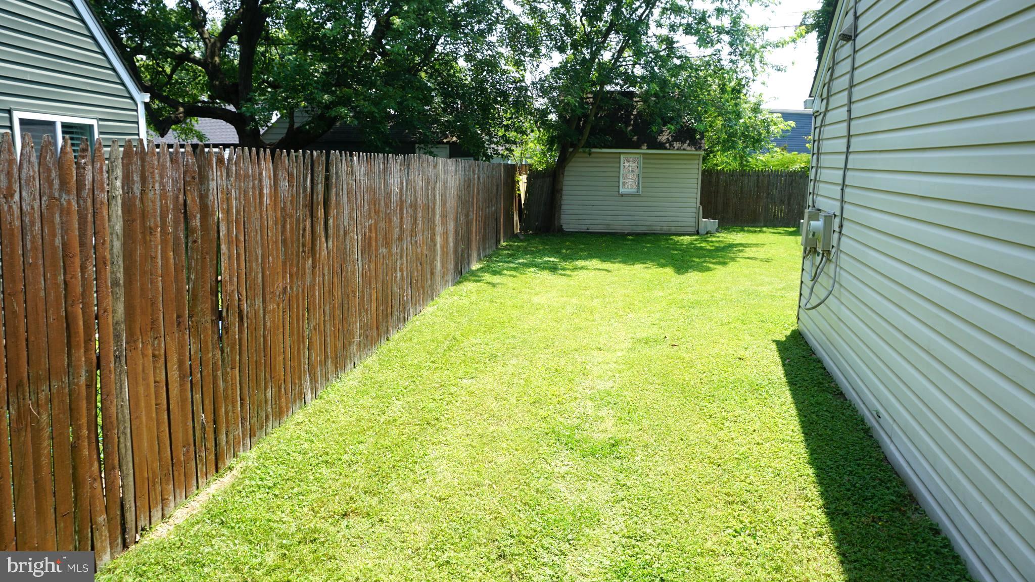 7811 Meath Road Baltimore, MD 21222 - Photo 37 of 52 a view of a backyard with wooden fence