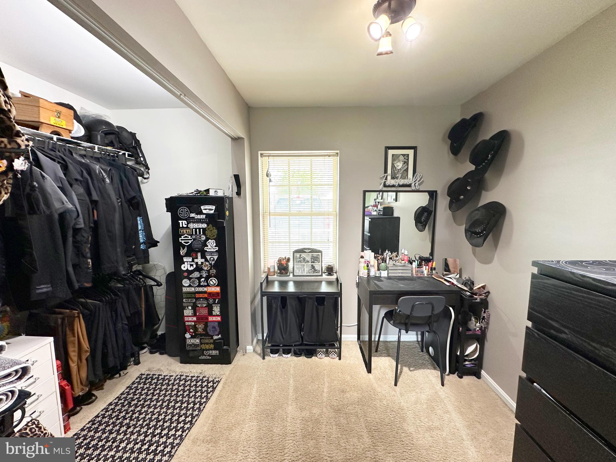 7811 Meath Road Baltimore, MD 21222 - Photo 5 of 52 a bedroom with a bed a walk in closet and a large window