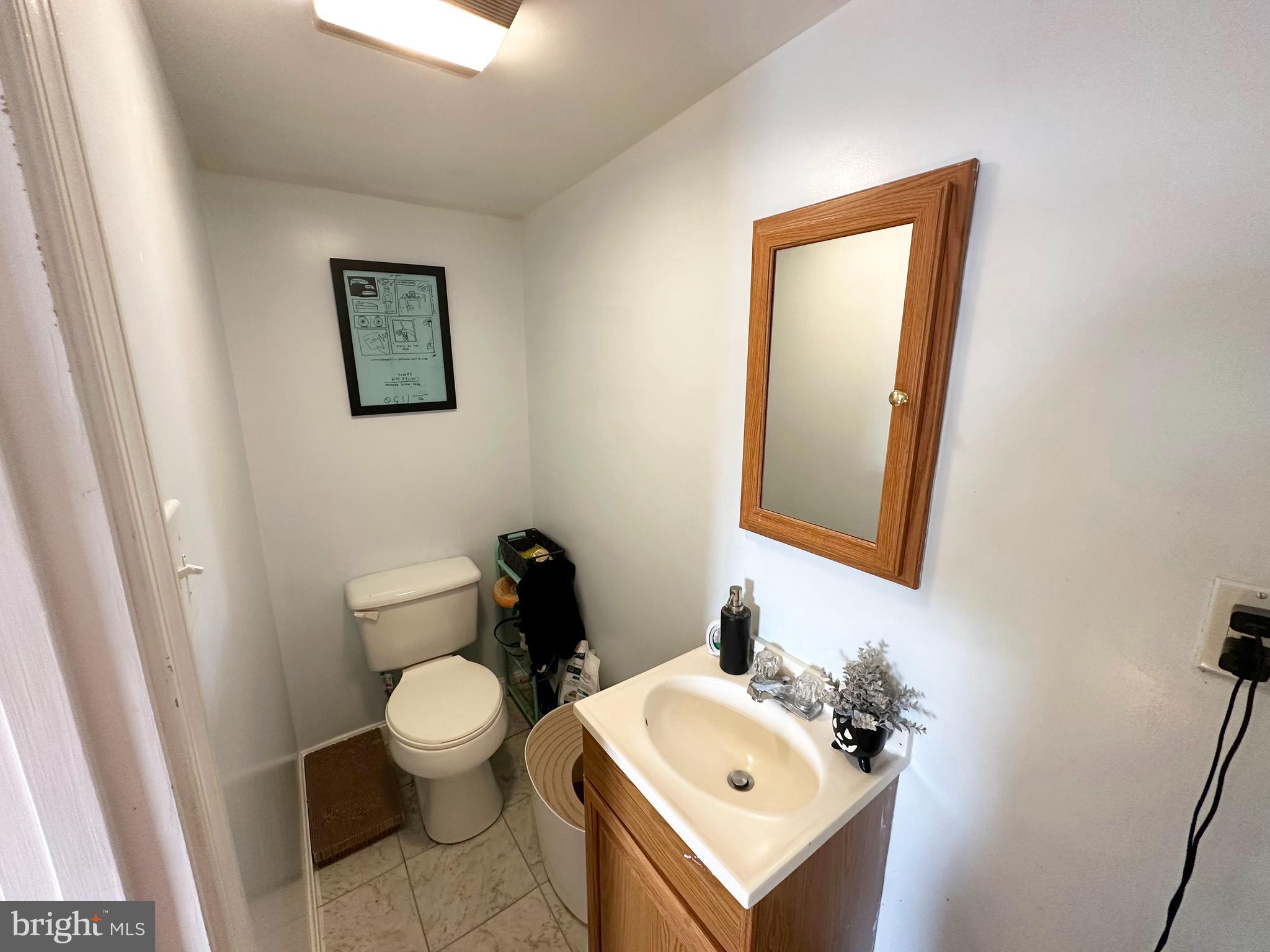 7811 Meath Road Baltimore, MD 21222 - Photo 8 of 52 a bathroom with a toilet sink and mirror