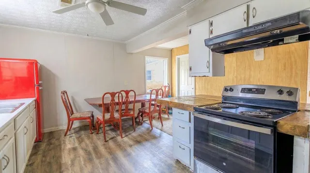 a dining room with furniture and wooden floor