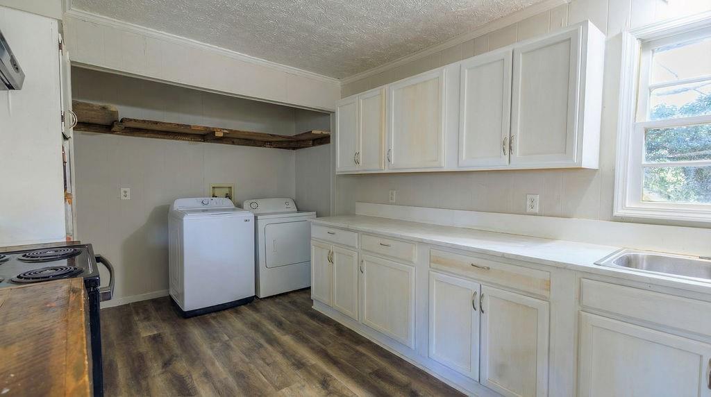 251 Killian Street Canton, GA 30114 - Photo 4 of 10 a utility room with cabinets washer and dryer
