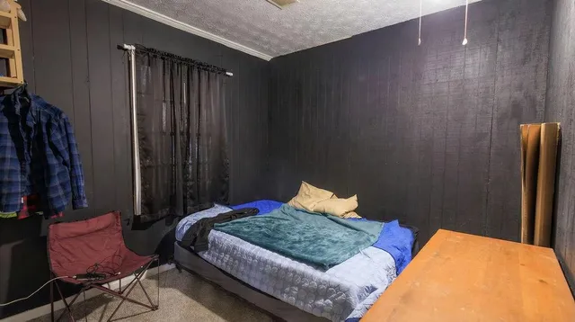 a bedroom with a bed and a chair