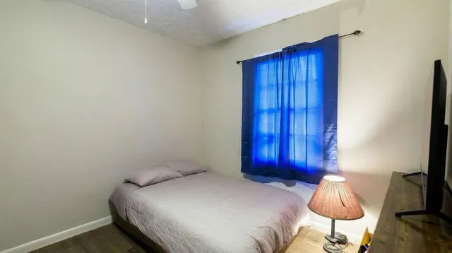 a bedroom with a bed and a chair