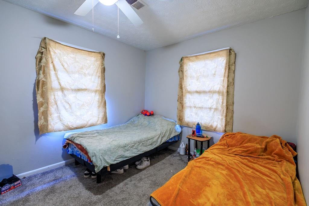 251 Killian Street Canton, GA 30114 - Photo 7 of 10 a bed room with a bed and a window