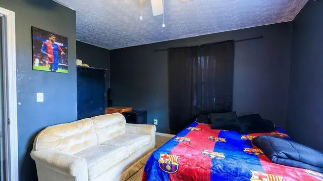 a bedroom with two bed and a lamp on table