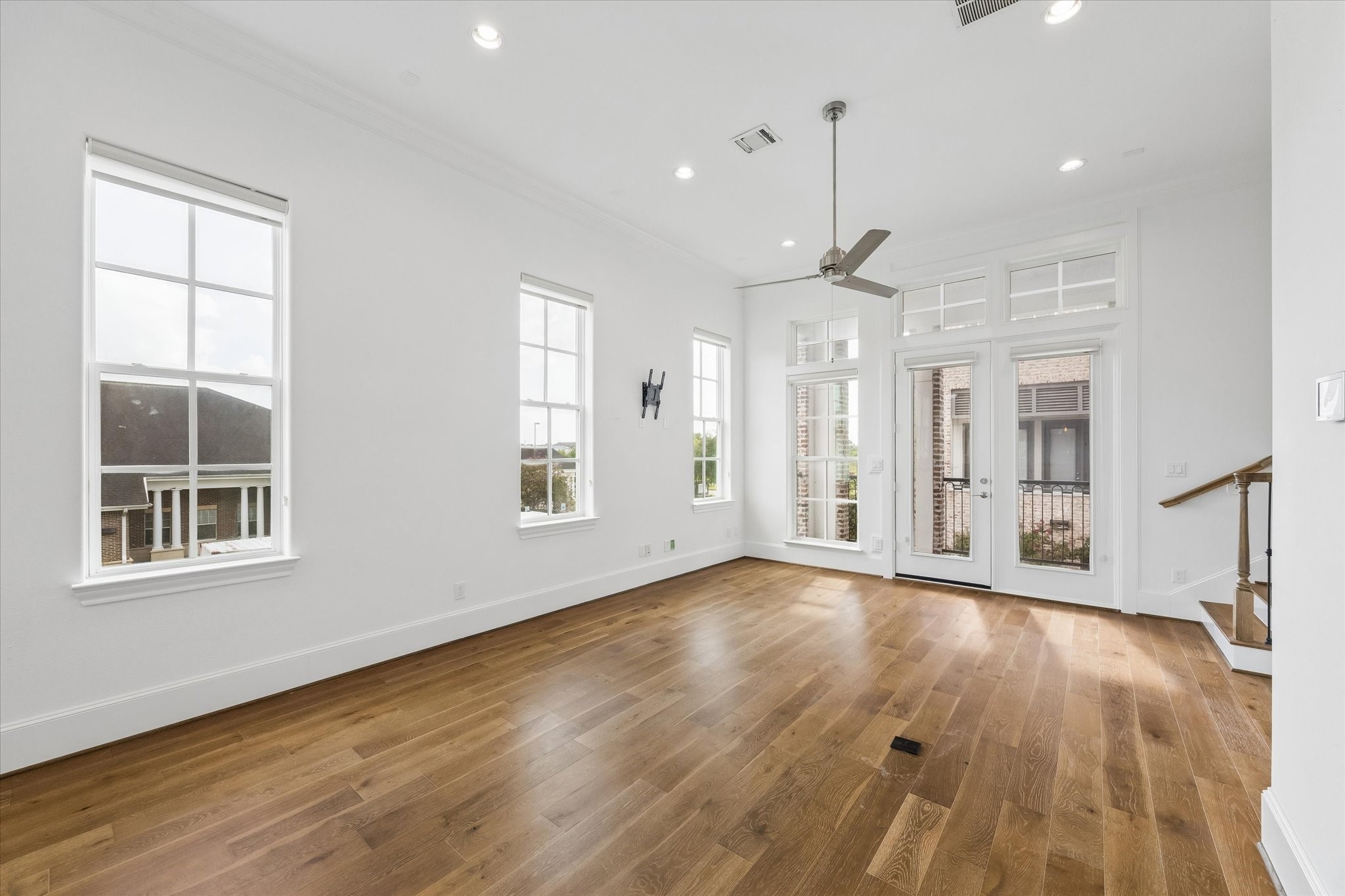 2024 Waterloo Station Road Houston, TX 77045 - Photo 6 of 19 The Living Room has 12 foot soaring ceilings, plenty of windows that flood the room with natural light, recessed lighting, hardwood floors & crown molding highlighting this area.