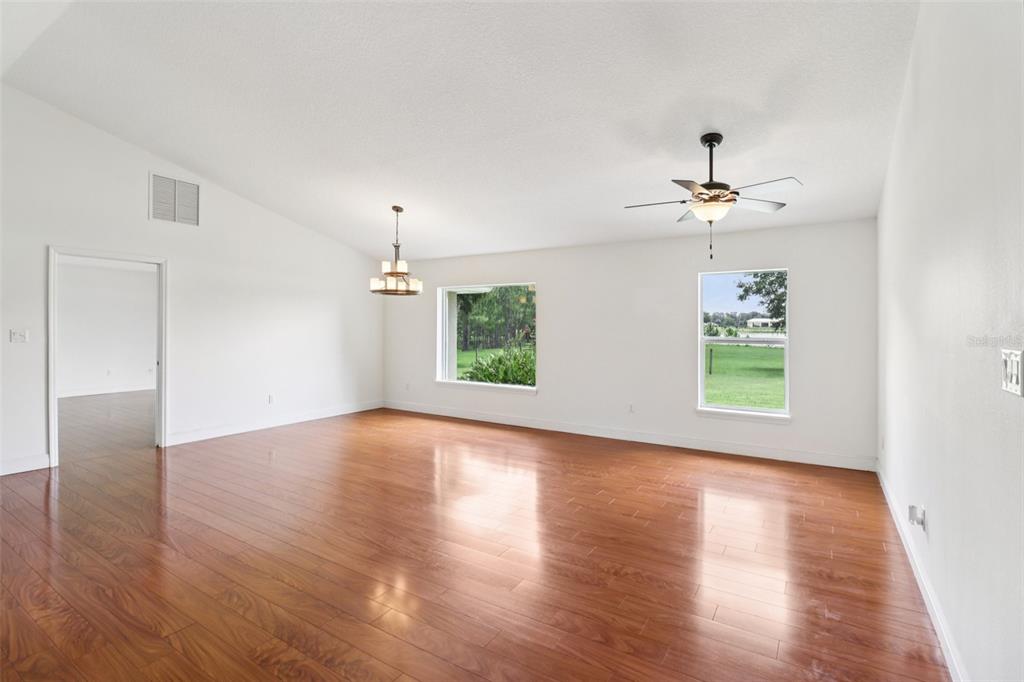 40610 Babb Road Umatilla, FL 32784 - Photo 13 of 45 a view of an empty room with wooden floor and a window