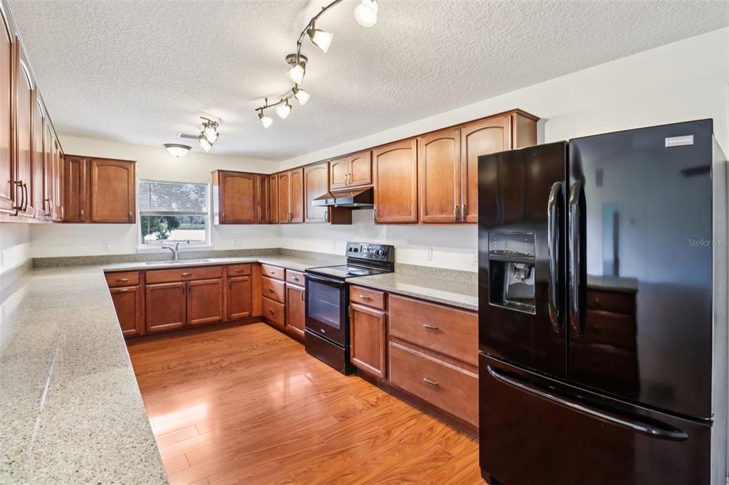 40610 Babb Road Umatilla, FL 32784 - Photo 15 of 45 a kitchen with granite countertop stainless steel appliances and wooden cabinets