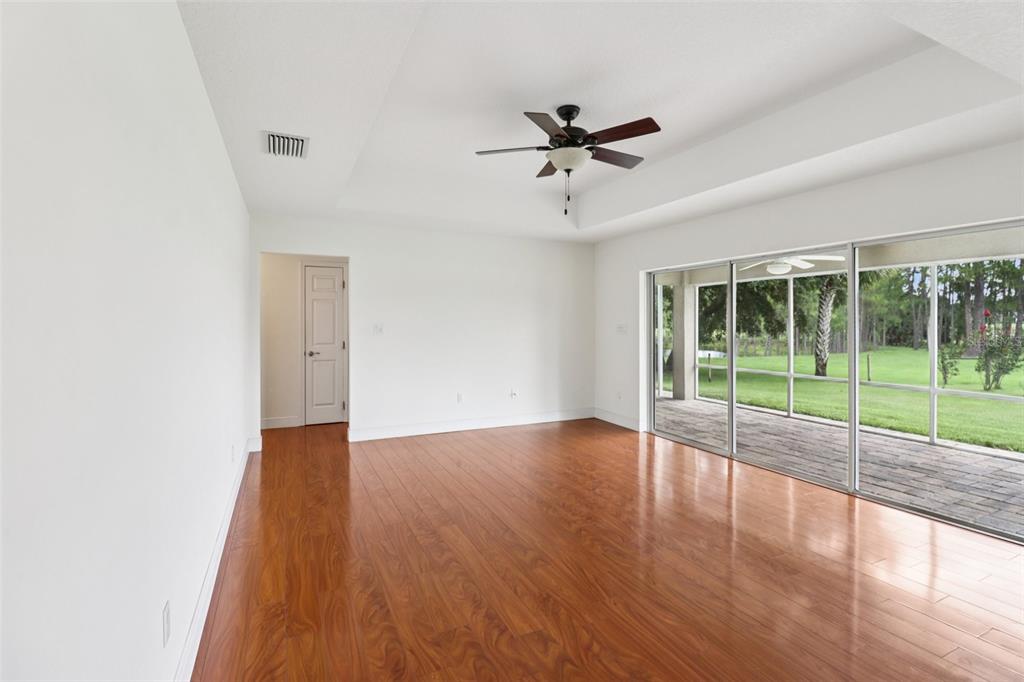 40610 Babb Road Umatilla, FL 32784 - Photo 17 of 45 a view of an empty room with wooden floor and a window