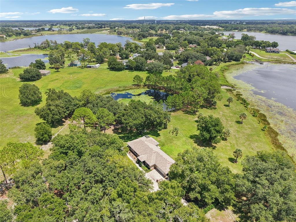 40610 Babb Road Umatilla, FL 32784 - Photo 38 of 45 an aerial view of a houses with a yard and lake view