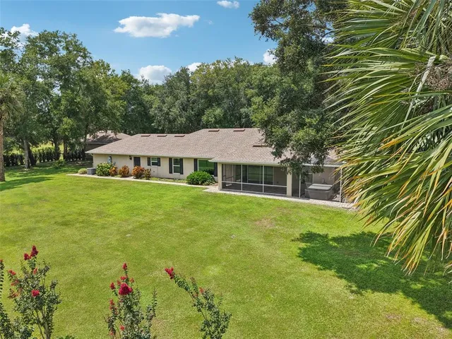 a aerial view of a house with swimming pool and garden