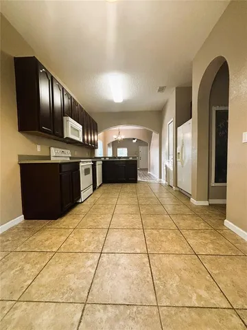 a kitchen with a stove a refrigerator and a sink