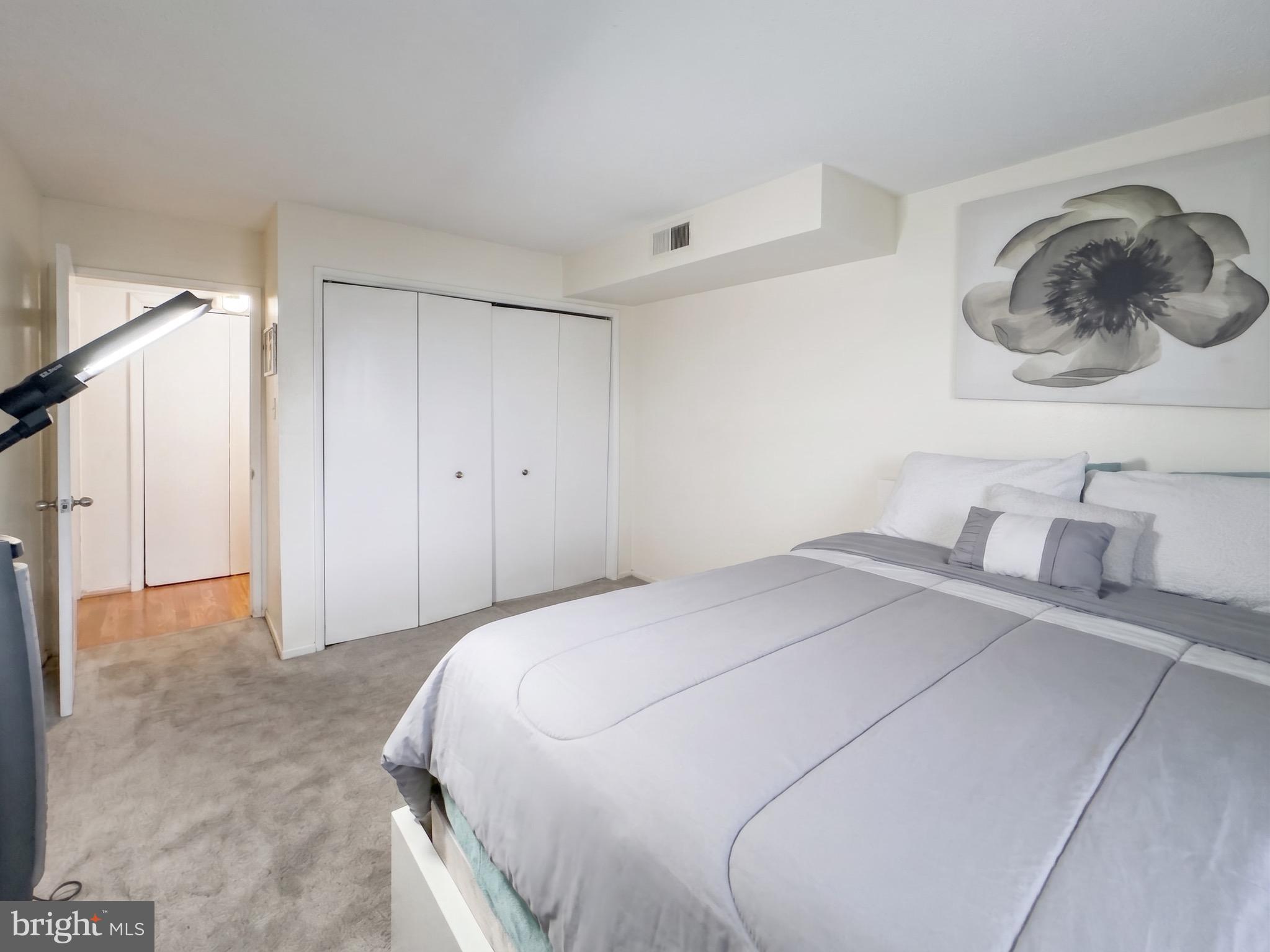 1822 Metzerott Road, Unit 401 Hyattsville, MD 20783 - Photo 12 of 22 a bedroom with a bed and walk in closet