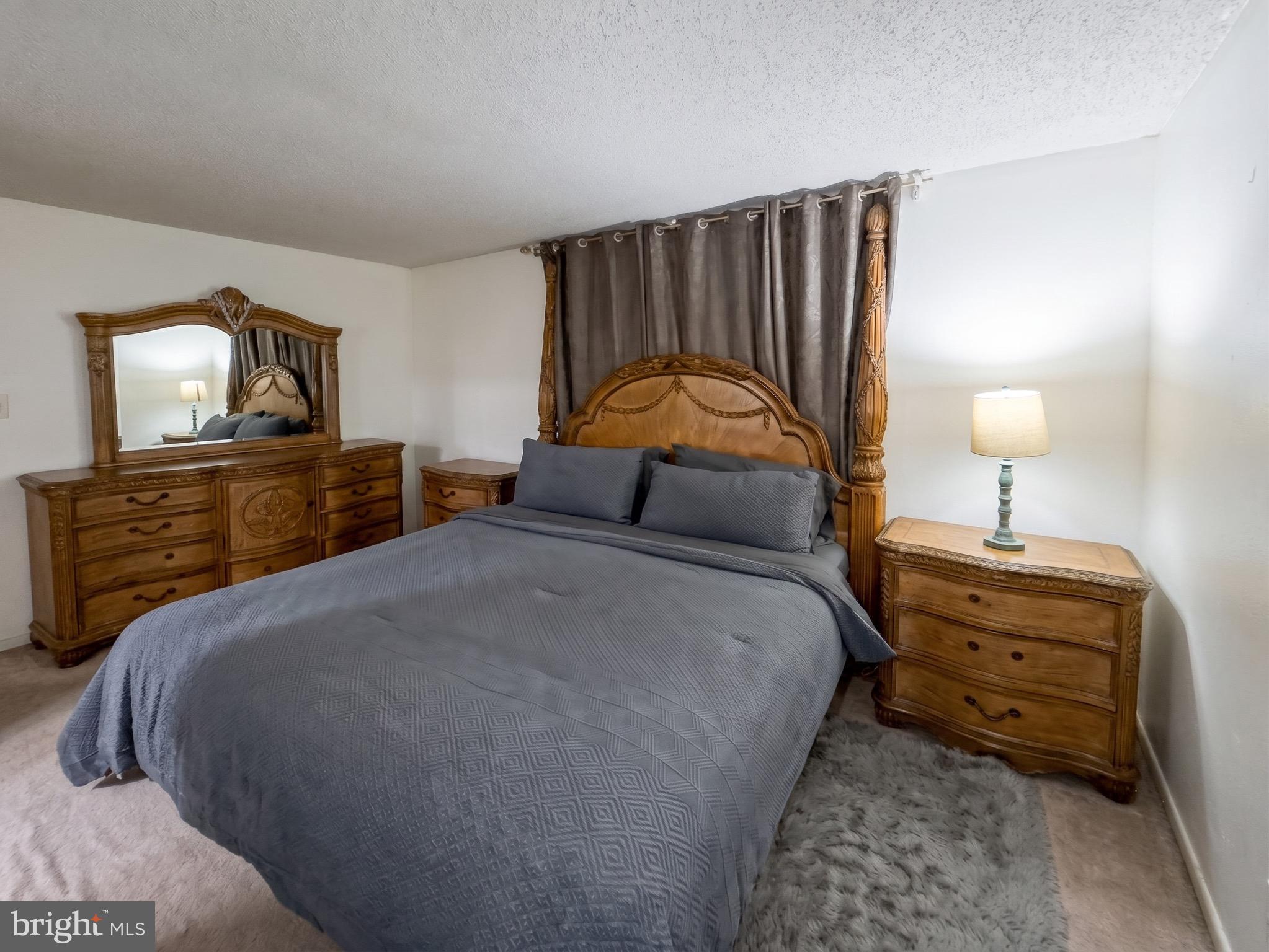 1822 Metzerott Road, Unit 401 Hyattsville, MD 20783 - Photo 16 of 22 a bedroom with a bed and a dresser