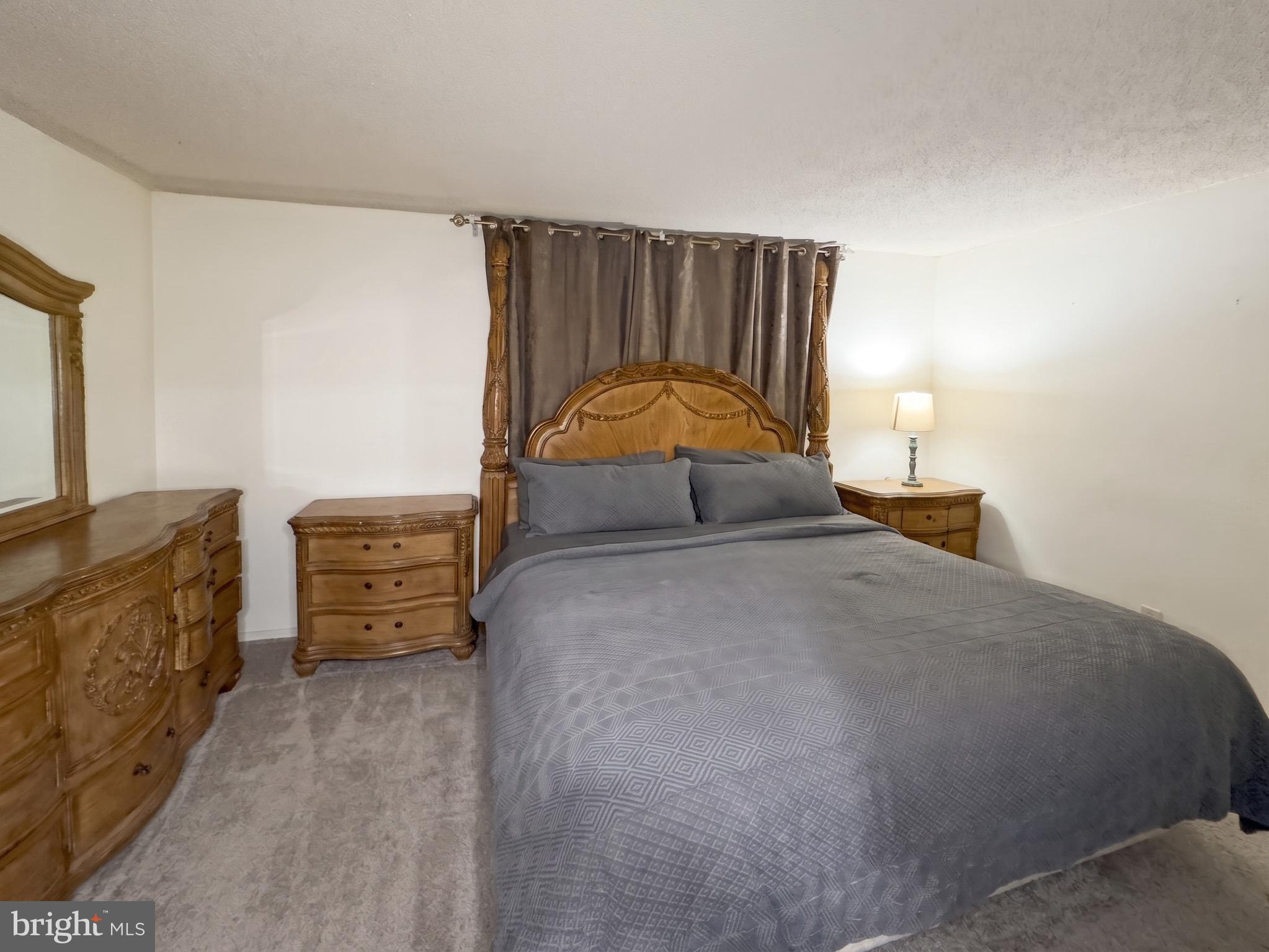 1822 Metzerott Road, Unit 401 Hyattsville, MD 20783 - Photo 17 of 22 a bedroom with a bed and furniture