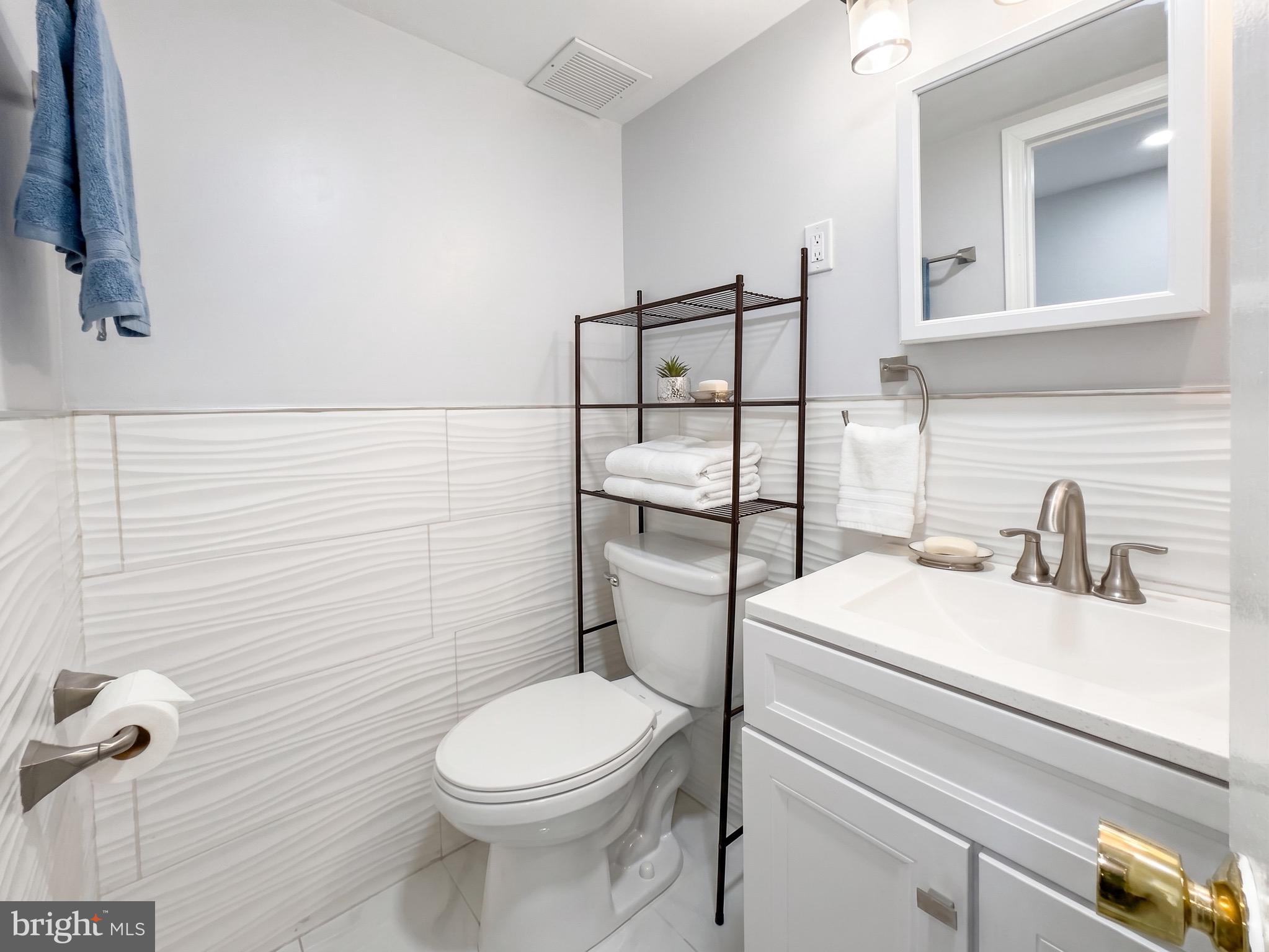 1822 Metzerott Road, Unit 401 Hyattsville, MD 20783 - Photo 19 of 22 a bathroom with a sink a toilet and mirror
