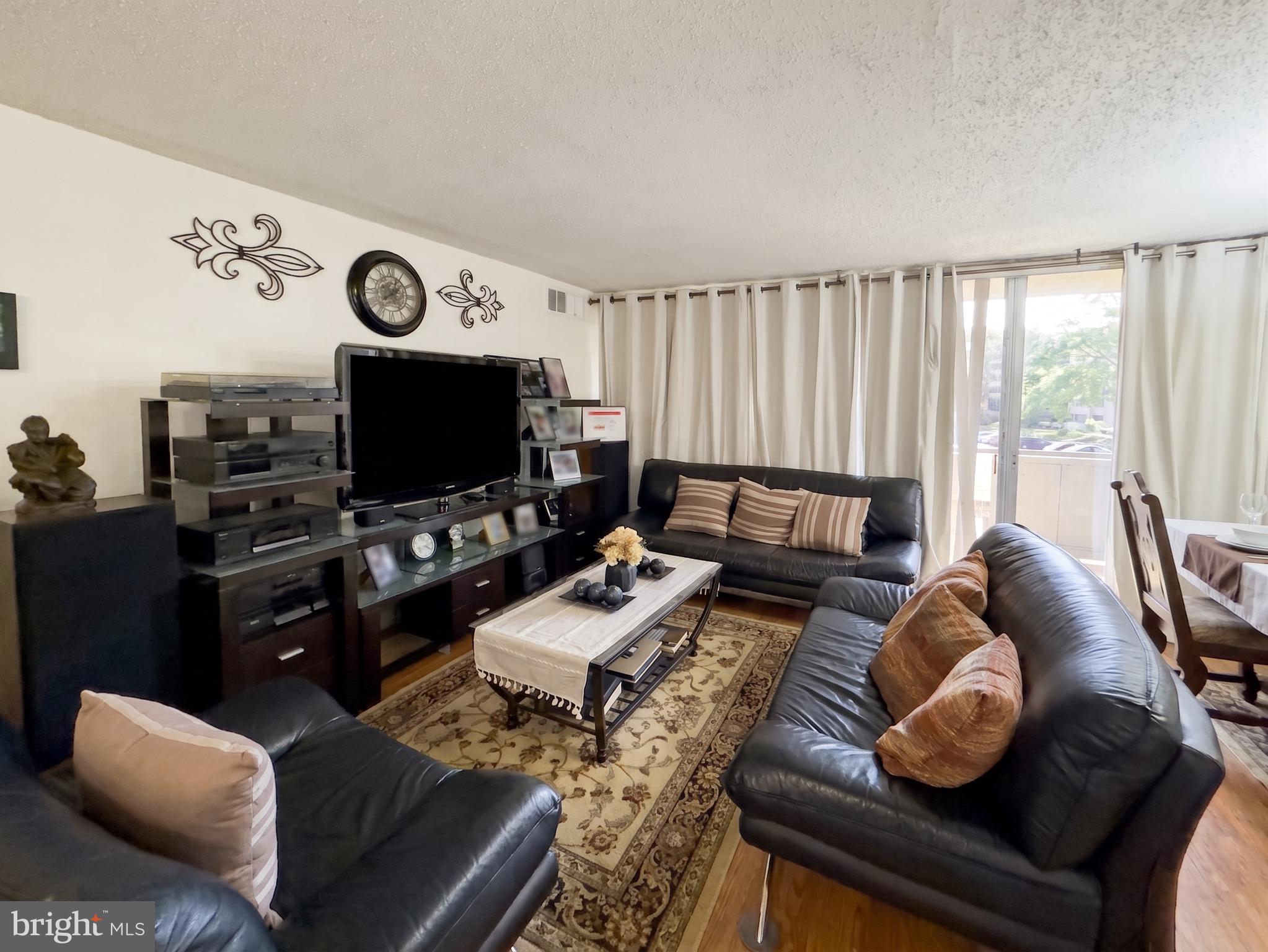 1822 Metzerott Road, Unit 401 Hyattsville, MD 20783 - Photo 4 of 22 a living room with furniture and a flat screen tv