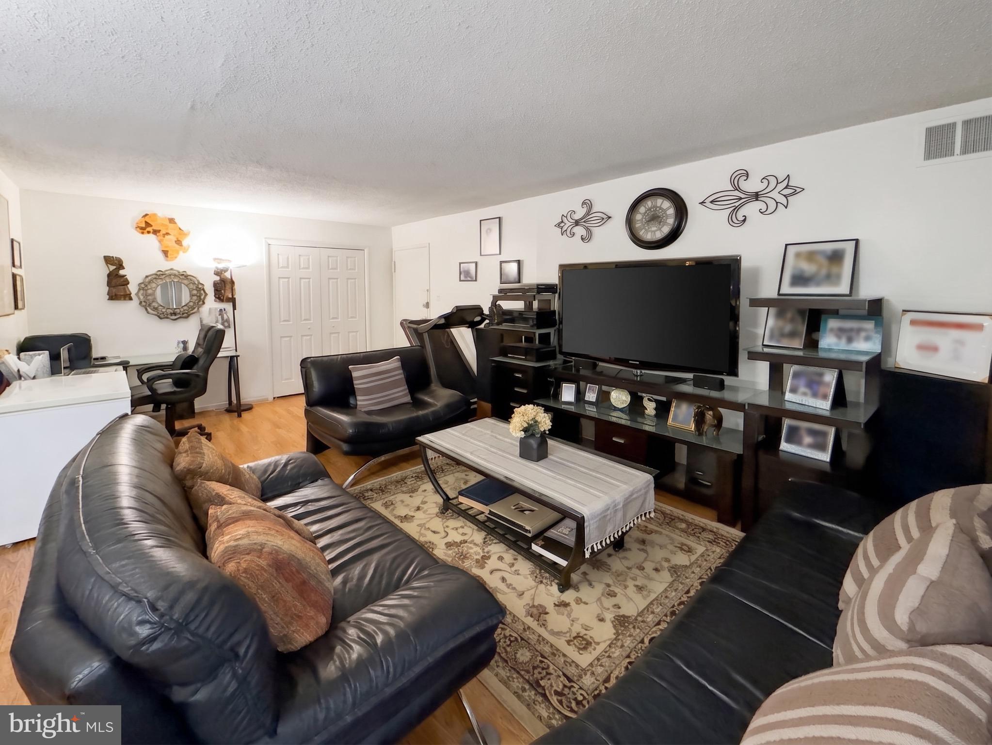 1822 Metzerott Road, Unit 401 Hyattsville, MD 20783 - Photo 5 of 22 a living room with furniture and a flat screen tv