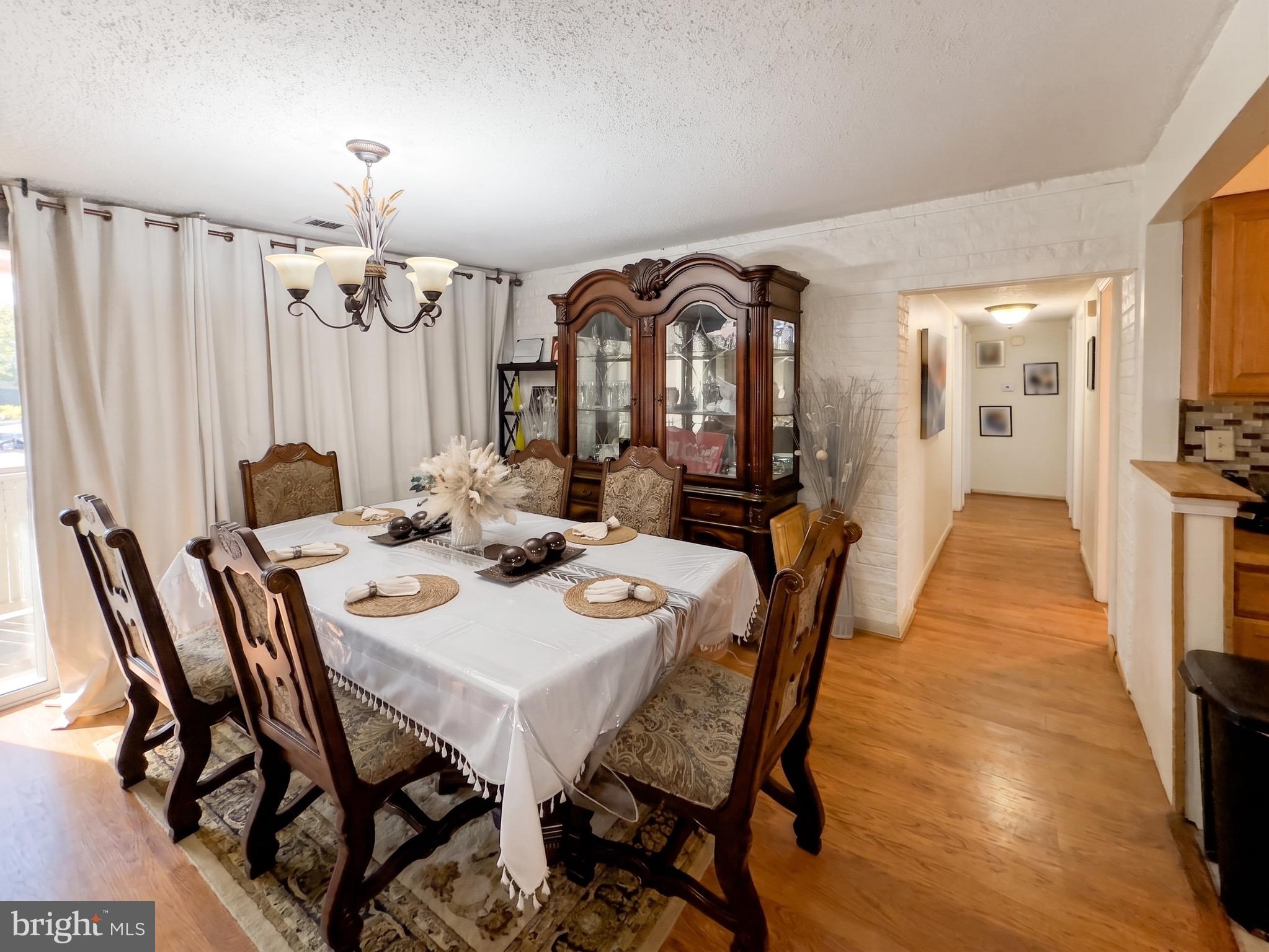 1822 Metzerott Road, Unit 401 Hyattsville, MD 20783 - Photo 7 of 22 a view of a dining room with furniture and wooden floor