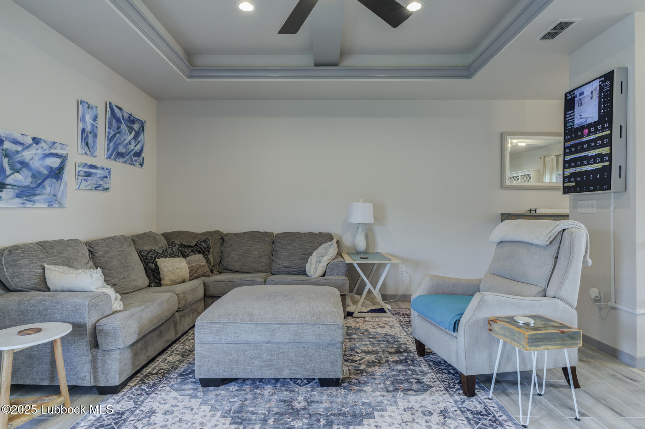5218 Lehigh Street Lubbock, TX 79416 - Photo 11 of 39 a living room with furniture a rug and a wall painting
