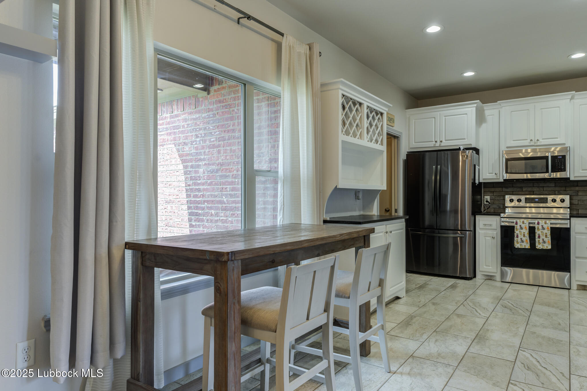 5218 Lehigh Street Lubbock, TX 79416 - Photo 15 of 39 a kitchen with stainless steel appliances a refrigerator and a stove top oven