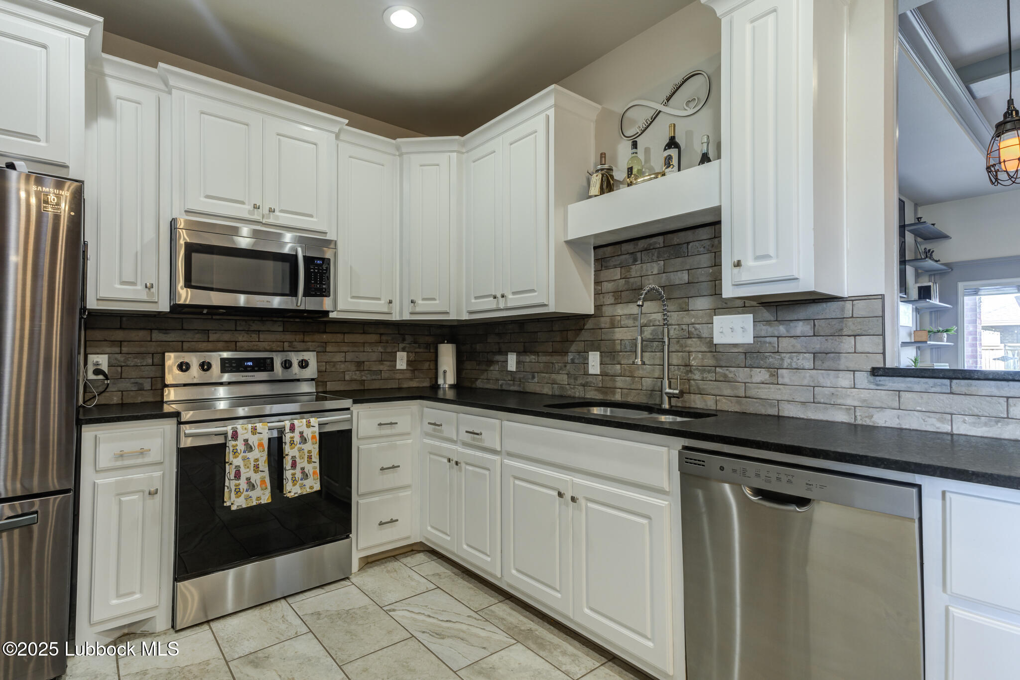 5218 Lehigh Street Lubbock, TX 79416 - Photo 18 of 39 a kitchen with stainless steel appliances granite countertop a sink and a stove