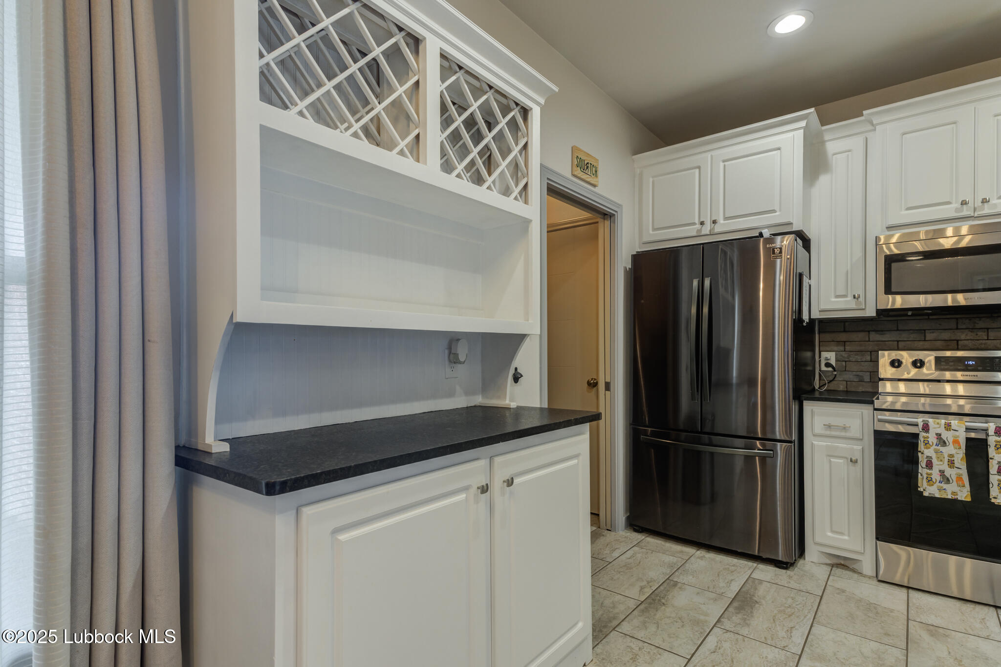 5218 Lehigh Street Lubbock, TX 79416 - Photo 21 of 39 a kitchen with stainless steel appliances a refrigerator and cabinets