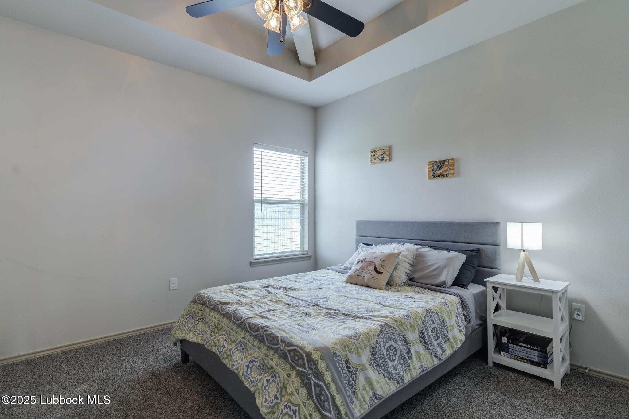 5218 Lehigh Street Lubbock, TX 79416 - Photo 24 of 39 a bedroom with a bed and a chandelier